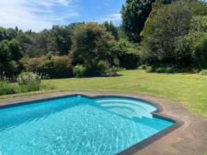 a swimming pool in a yard with a garden at Briar & Bloom 1 in Hilton