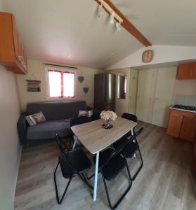 a living room with a table and chairs and a couch at Le doux refuge de l'Yères in Touffreville-sur-Eu +14 photos