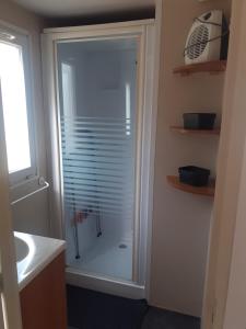 a shower with a glass door in a bathroom at Le doux refuge de l'Yères in Touffreville-sur-Eu