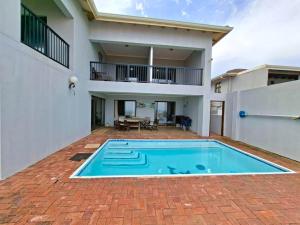 a swimming pool in the backyard of a house at Waveside Guesthouse in Durban
