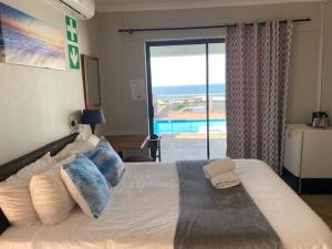a bedroom with a bed with a view of a pool at Waveside Guesthouse in Durban +37 photos