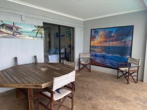 a dining room with a wooden table and chairs at Waveside Guesthouse in Durban