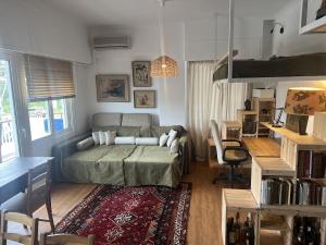 a living room with a bed and a desk at Beachfront Apprtment on Athens Riviera in Saronida