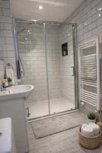 a bathroom with a shower and a sink at Careful Cottage in Crediton