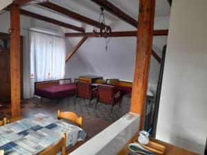 a room with a table and chairs and a dining room at apartman liker in Ravna Gora