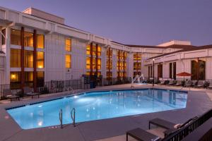 a large swimming pool in front of a building at DoubleTree By Hilton Sacramento in Sacramento
