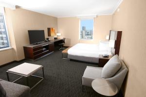 a hotel room with a bed and a television at Hilton San Francisco Union Square in San Francisco