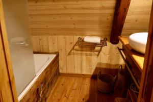 a small bathroom with a tub and a sink at Authentic chalet in Saint-Jean-dʼArves +10 photos