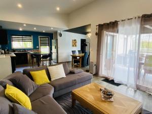 a living room with a couch and a table at Les TERRASSES DE LAYOULE in Rodez