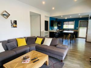 a living room with a couch and a table at Les TERRASSES DE LAYOULE in Rodez