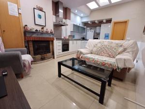 a living room with a couch and a coffee table at SELA HOME y Garaje, Algemesi Home in Algemesí