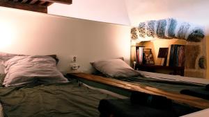 a bedroom with a bed with a mirror on the wall at Chambres La Prévôté - Randonneurs et Pèlerins - Ancien couvent contre la Cathédrale in Le Puy-en-Velay