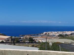 a view of a city with the ocean in the background at local diamond in Guía de Isora +15 photos