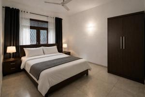 a bedroom with a large bed and a window at Long Villa in Kandy