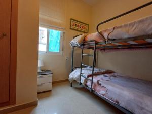a bedroom with two bunk beds and a window at SELA HOME y Garaje, Algemesi Home in Algemesí