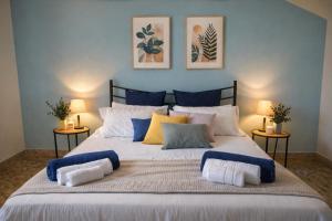 a bedroom with a large bed with blue walls at Villa 70 in Peschiera del Garda