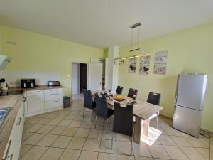 a kitchen and dining room with a table and chairs at Ferienhaus Ruth in Walow