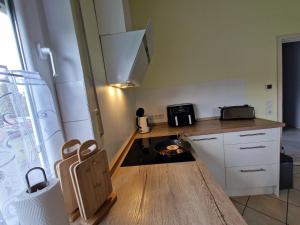 a small kitchen with a stove and a microwave at Ferienhaus Ruth in Walow