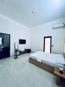 a bedroom with a bed and a flat screen tv at Tie Homestay in Dong Hoi