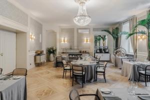 a restaurant with tables and chairs and a kitchen at Hotel Unicus Palace Old Town - Destigo Hotels in Krakow