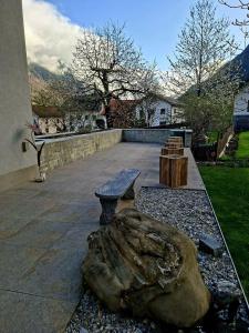 a bench and a rock and a log at Alpenchalet S´Andalr in Pfunds +12 photos
