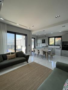 a living room with a couch and a table with chairs at Villa Gaia in Selçuk
