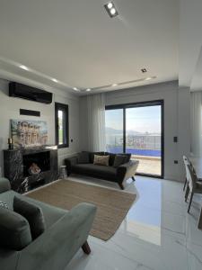 a living room with a couch and a fireplace at Villa Gaia in Selçuk