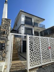 a house with a gate in front of it at Villa Gaia in Selçuk