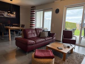 a living room with a couch and a table at Villa Grande Fewo Enjoy We 2 in Göhren-Lebbin