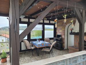 a patio with a table and chairs and a fireplace at Ferienwohnung Amano in Fischbach