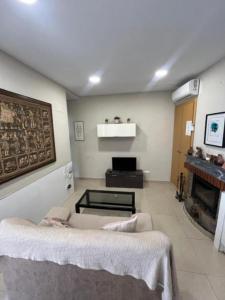a living room with a couch and a fireplace at SELA HOME y Garaje, Algemesi Home in Algemesí