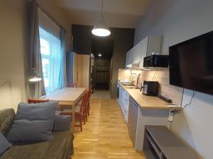 a kitchen with a couch and a table in a room at Robezu apartments 14 in Riga