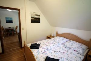 a bedroom with a bed in a room with a table at Deichkoje 06 in Prerow