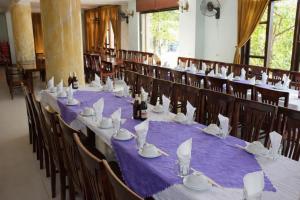 a dining room with purple table cloths and chairs at Bạch Tuyết Hotel in Cửa Lô