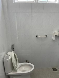a bathroom with a toilet with the lid up at Beachside home 2 in Phú Quốc