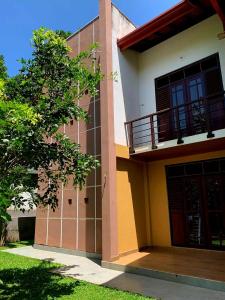 a building with a balcony on the side of it at AR 7 Villa Mirissa in Matara