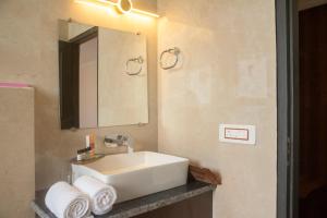 a bathroom with a sink and a mirror and towels at Hardys Retreat in Mai Jūbar +55 photos