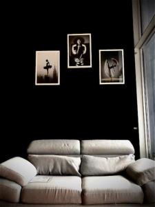 a living room with a couch and pictures on the wall at Private Luxury Loft in Crescenzago