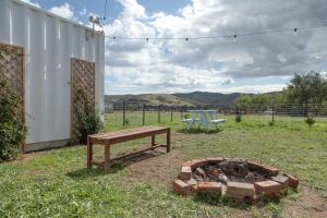 a picnic table and a bench in a yard at Zamenhof River Cabin - Peaceful Farm Escape - Pets Welcome in Yass