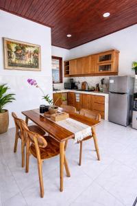 a kitchen with a wooden table and chairs at Molog private villa in Ubud