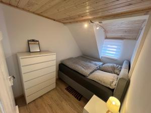 a small bedroom with a bed and a dresser at D1 - Klein aber fein in Wernigerode