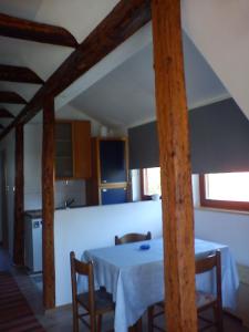 a kitchen with a table and chairs in a room at apartman liker in Ravna Gora