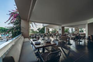 a restaurant with tables and chairs and a balcony at Paloma Perissia in Side