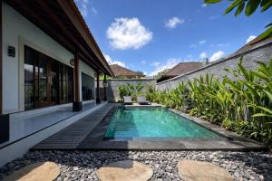 a swimming pool in the backyard of a villa at Molog private villa in Ubud