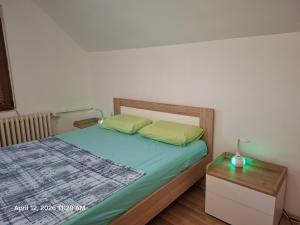 a bedroom with a bed and a night stand with a lamp at Garden Vila in Gevgelija
