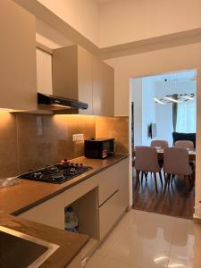 a kitchen with a stove top oven next to a dining room at Luxury Golf and Relaxation in Gonapola