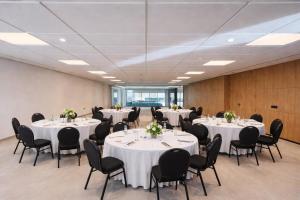 a conference room with white tables and black chairs at L'ADRESSE Boutique Hôtel & SPA Tanger in Tangier +37 photos