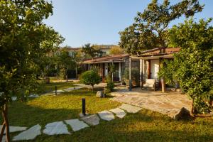 a house with a yard with a stone walkway at Selimiye Sardunya Hotel & Restaurant in Marmaris