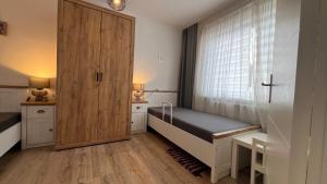 a bedroom with a bed and a large window at A2 - Viel Platz für alle in Wernigerode