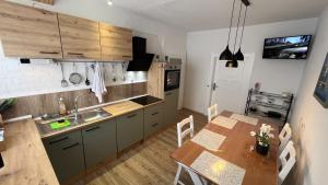 a kitchen with a table and a dining room at A2 - Viel Platz für alle in Wernigerode +27 photos